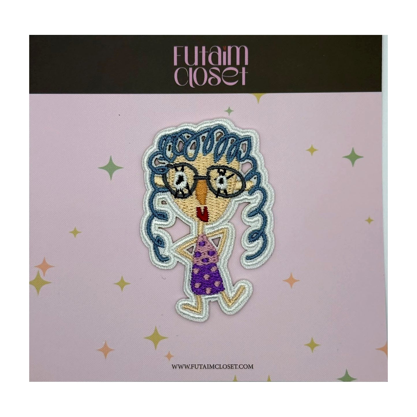 Embroidered patch of a girl with glasses and blue curly hair on a Futaim Closet card