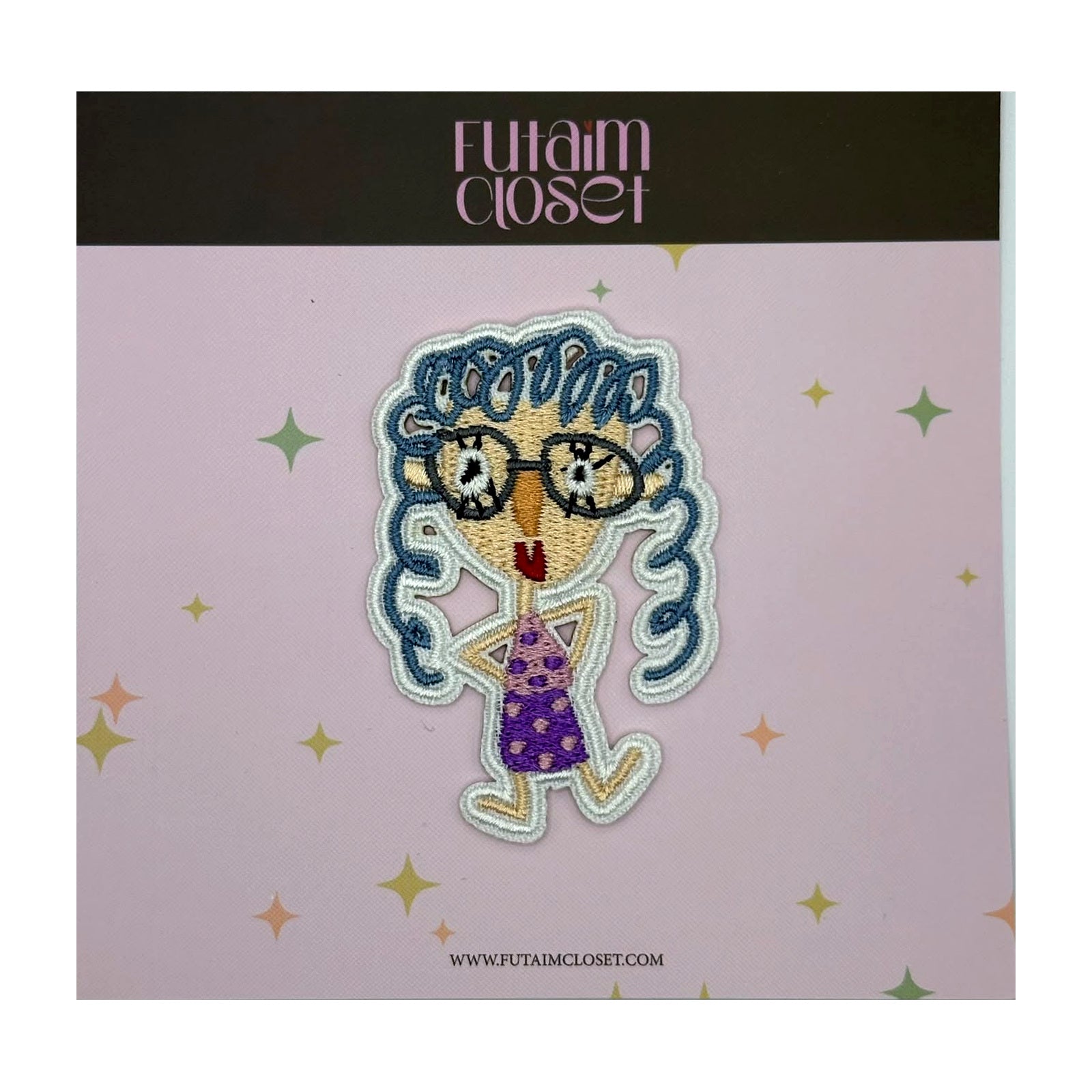 Embroidered patch of a girl with glasses and blue curly hair on a Futaim Closet card